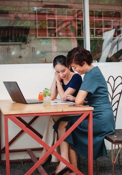 Asian woman browsing a tablet in a cafe