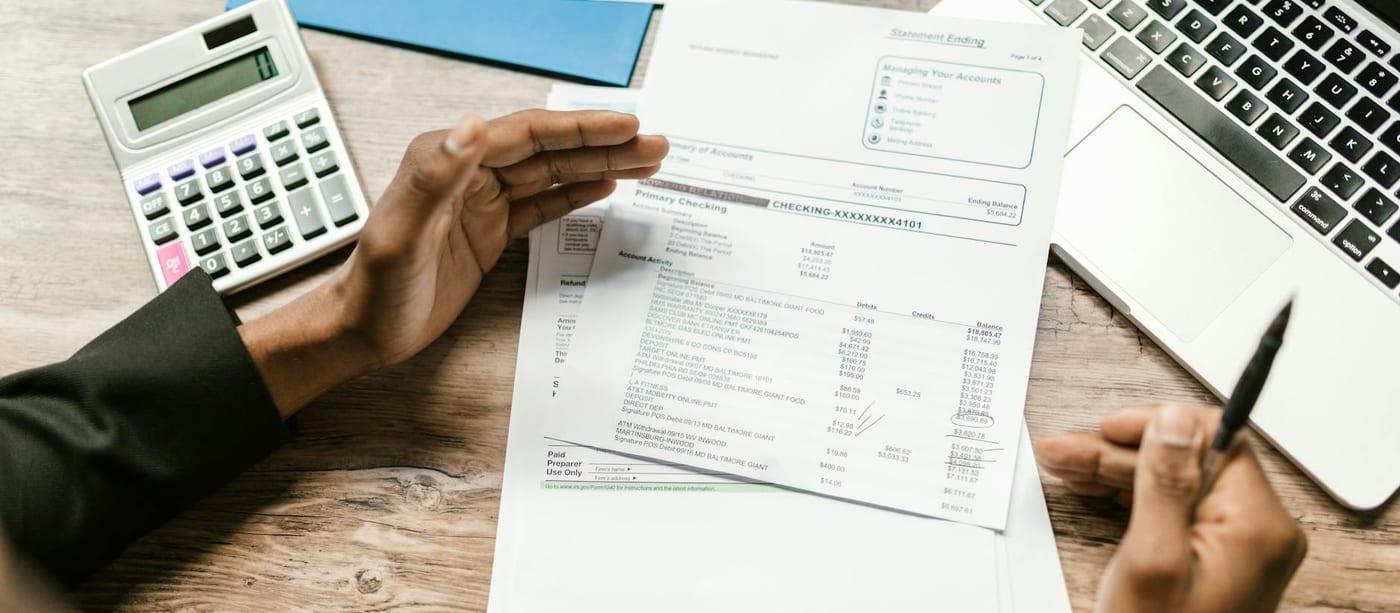 Invoice documents and account records arranged for review as part of an ageing report workflow