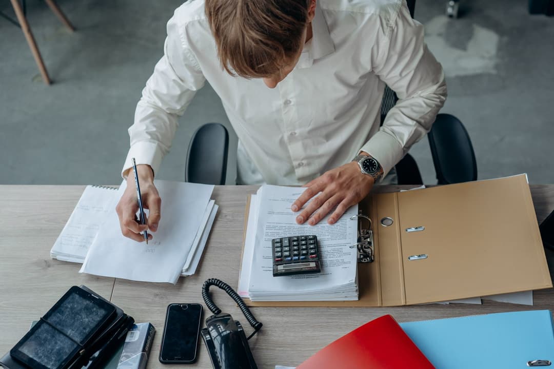 Finance administrator reviewing payments, expenses and supplier invoices before closing the period