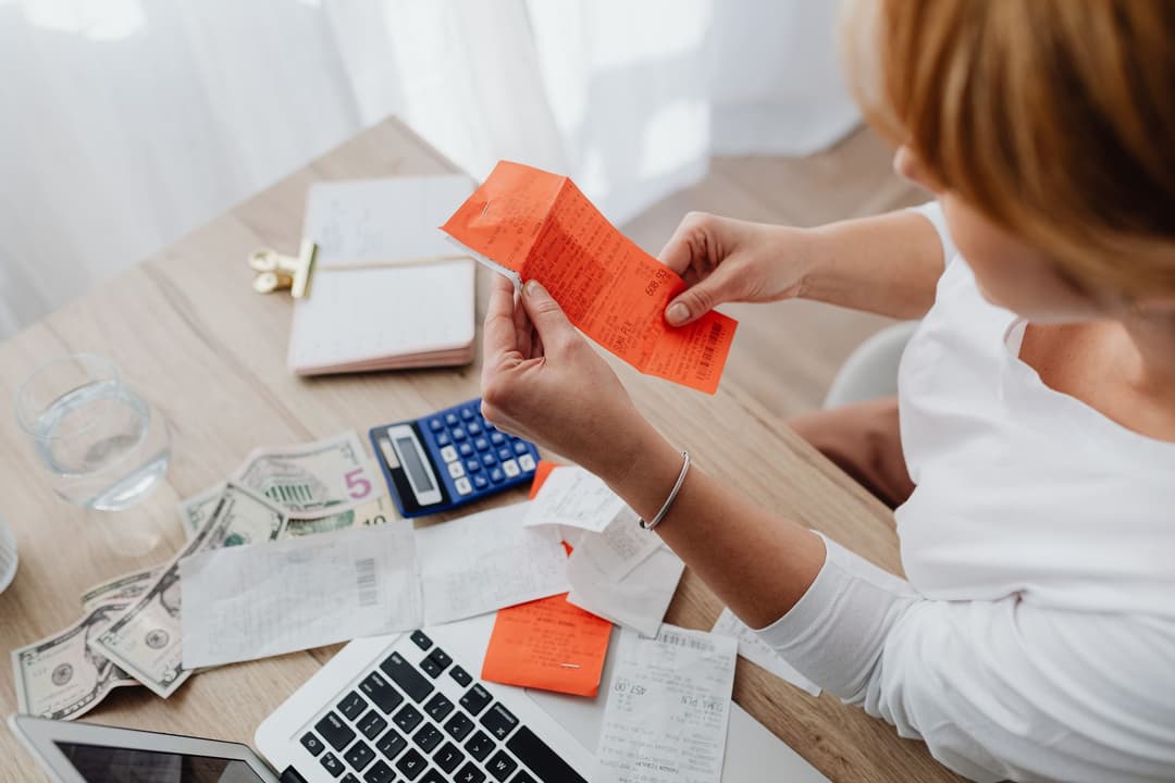 Operating expense bills organised by category beside an expense record