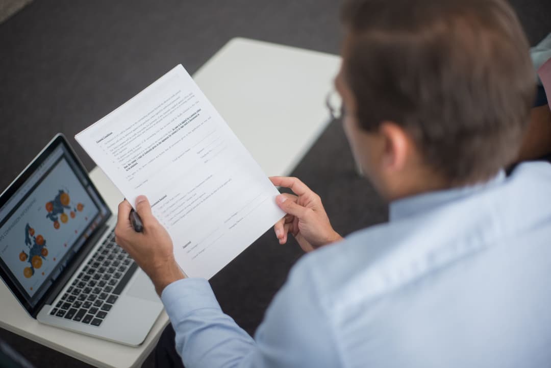 Purchasing manager reviewing the final supplier choice recorded with a purchase order