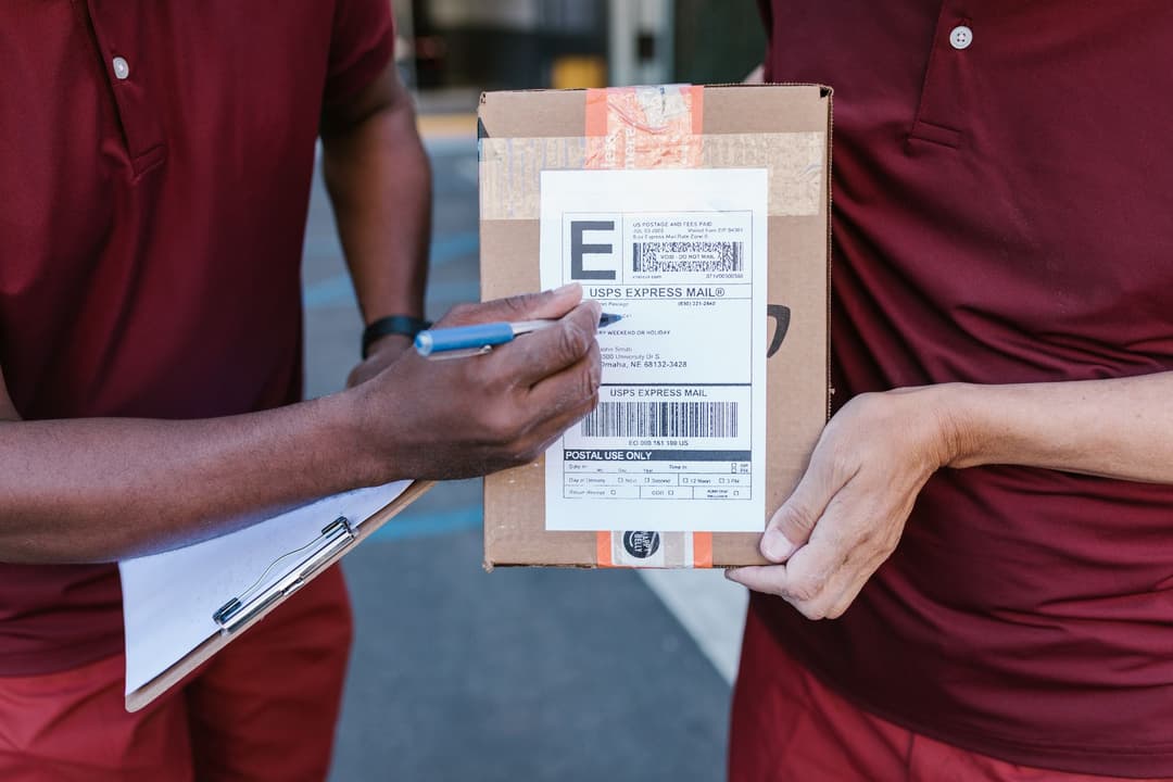 Warehouse staff checking delivered goods against revised purchase order details