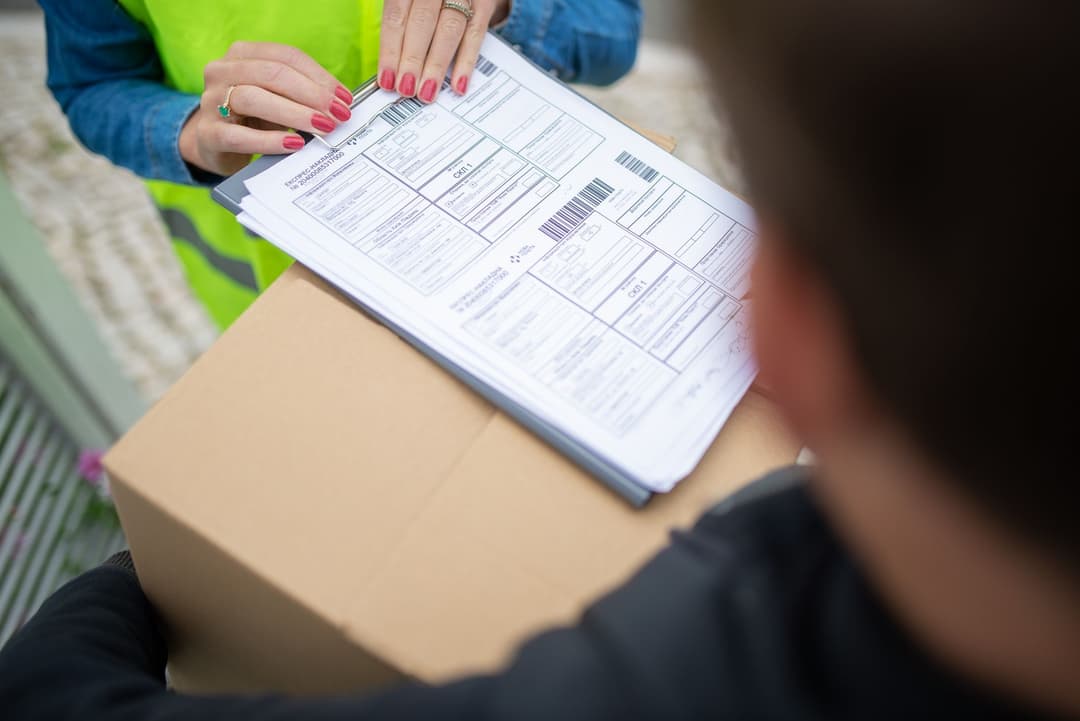 Receiving staff member confirming a delivery at the correct warehouse entrance