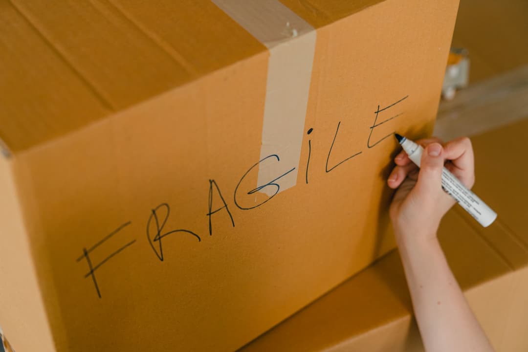 Warehouse staff matching packed items and delivered quantities against a delivery order