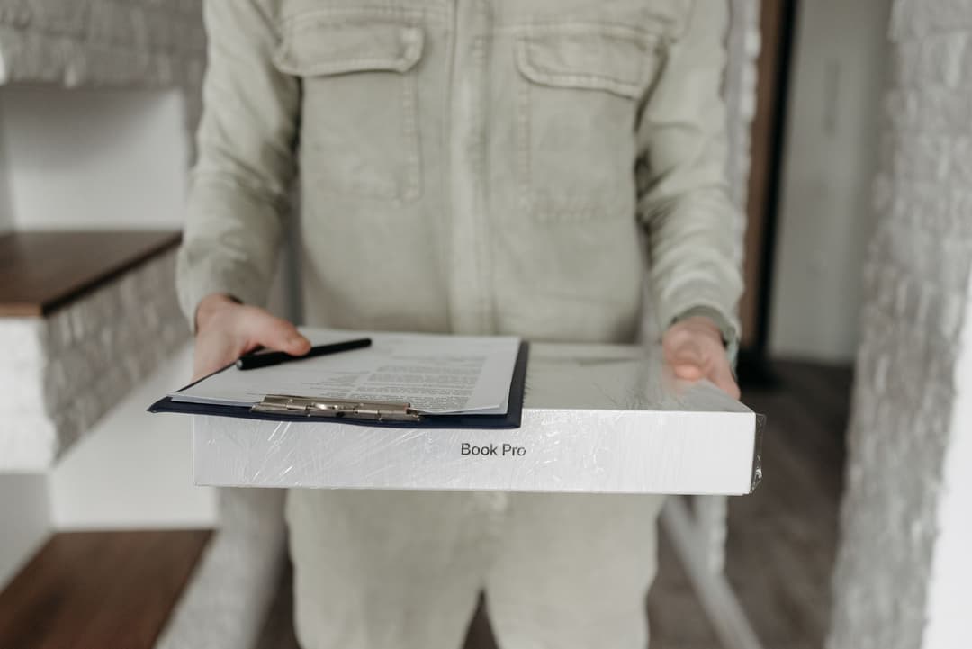 Warehouse coordinator photographing delivered goods as delivery proof