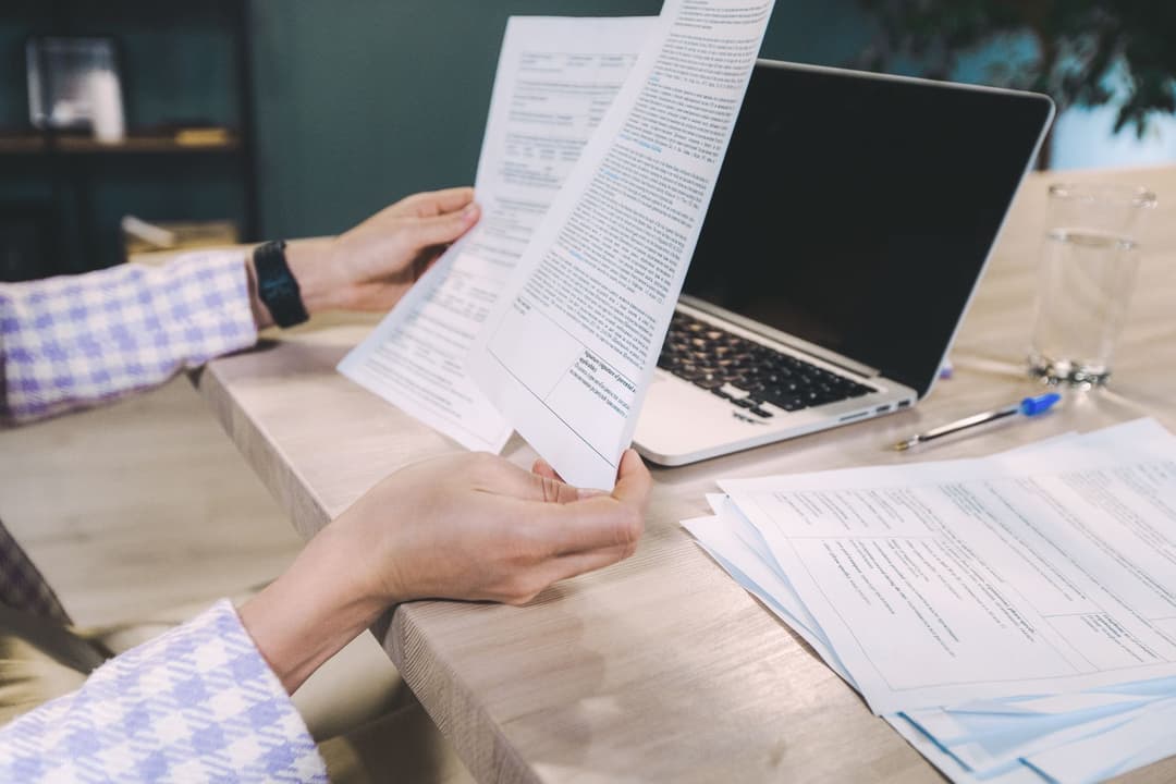 Procurement administrator checking a supplier bill against purchasing documents