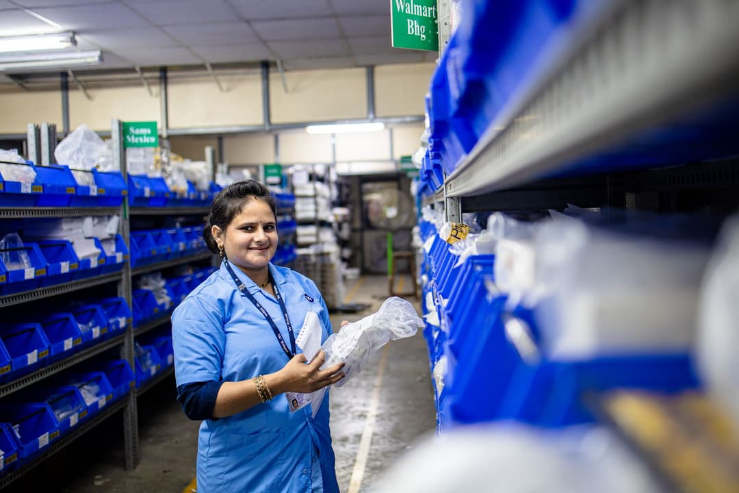 Warehouse employee photographing damaged stock before recording an adjustment