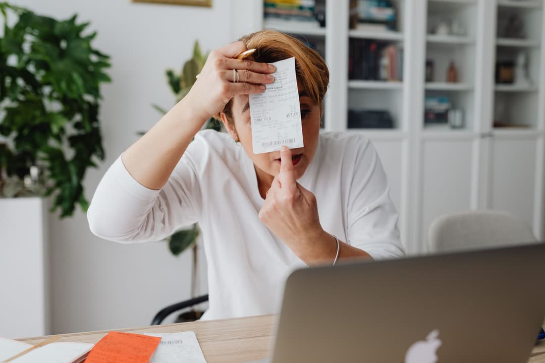 Customer service employee reviewing payment records while answering a customer query