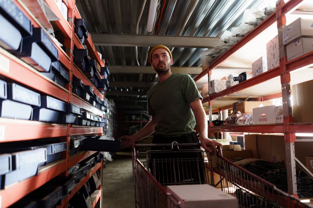 Warehouse picker checking item quantities against a picking list