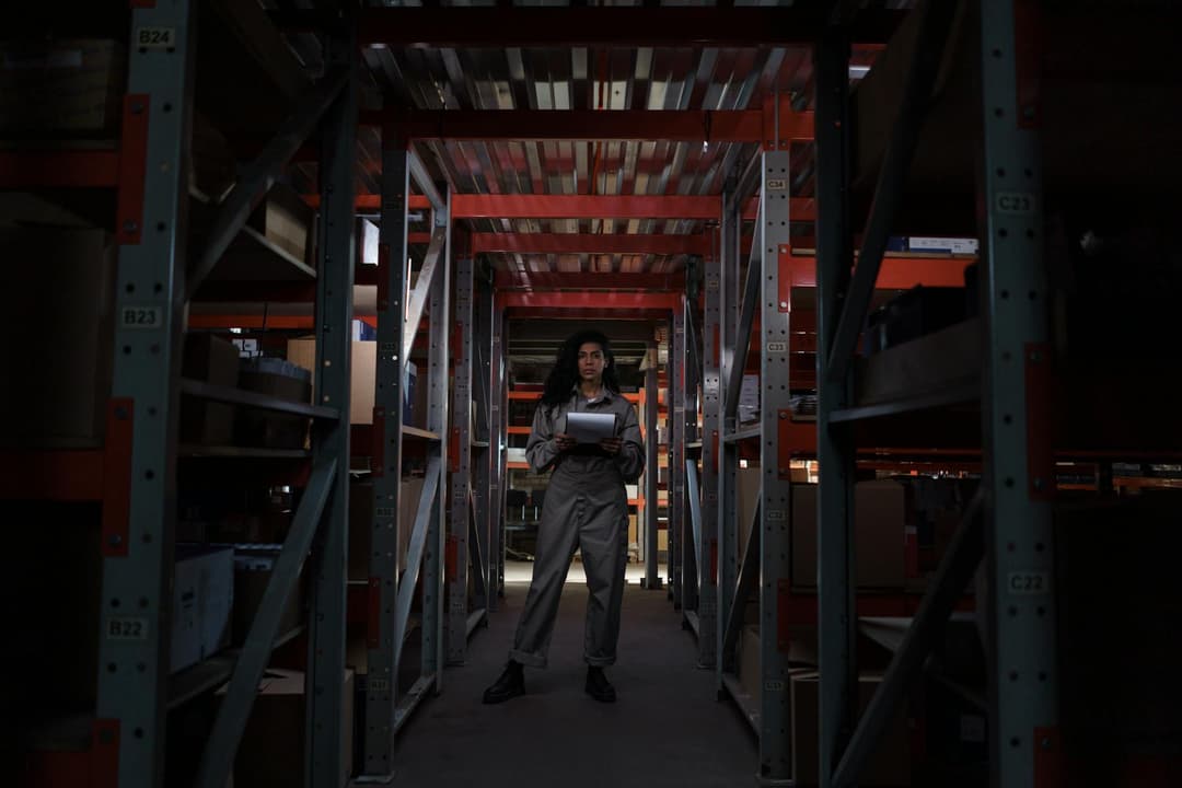 Warehouse worker checking inventory by storage location